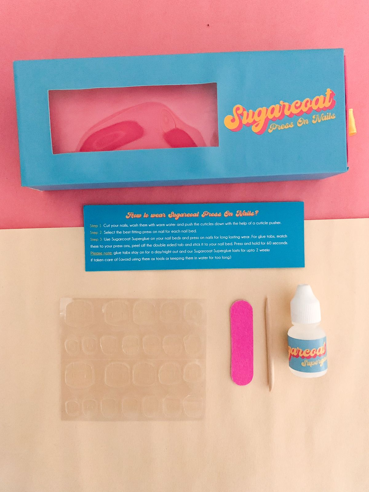 Complete Sugarcoat Press-On Nails Kit with glue tabs, nail glue, cuticle pusher, and nail file for a professional and convenient manicure experience.